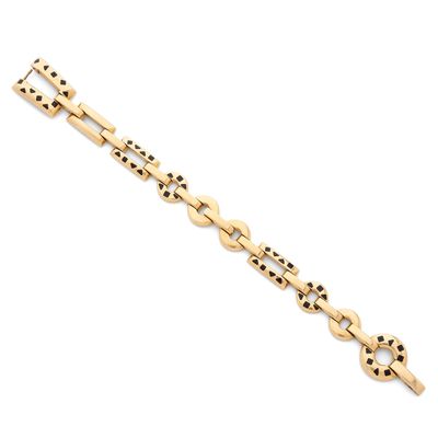 un bracelet en or orné de petits points noirs