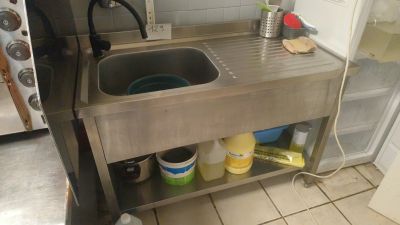 a stainless steel sink in a kitchen next to a stove