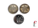 three different types of coins are shown on a white surface