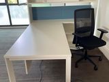 a white desk with a black chair in front of it