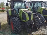 three green tractors parked next to each other on the side of the road