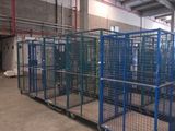 a large cage in the middle of a warehouse