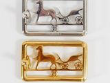 two silver and gold plated horse and carriage brooches