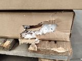 a cardboard box sitting on top of a wooden bench