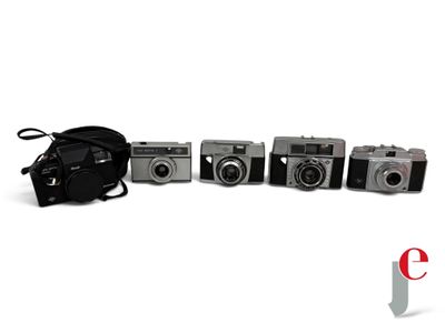 five cameras sitting next to each other on a white surface