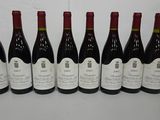 six bottles of wine are lined up on a table