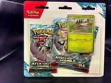 two pokemon cards are in a package on a black surface