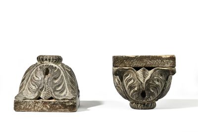 two small vases are sitting next to each other on a white surface