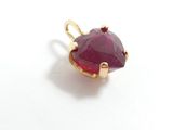 ruby heart shaped pendant with gold plated setting on a white background