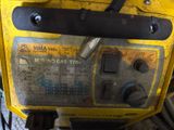 the back of a yellow machine that is sitting on the ground