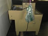 a bag of food hanging from a machine in a kitchen