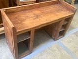 a wooden bench that is sitting in the middle of a room