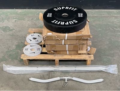a box with a tire on a pallet next to a pair of scissors