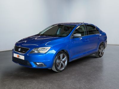the blue car is parked in a white room with a black floor