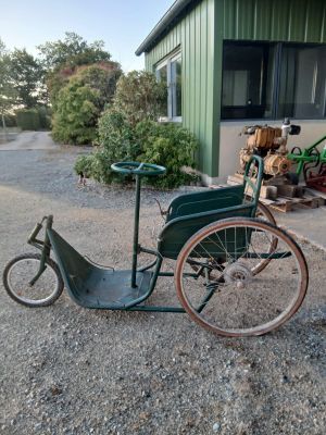 a small green bike parked in front of a building