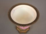 a white bowl with a pink decoration on it