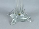 a clear glass vase with a green flower inside of it