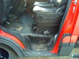 a red car with a suitcase in the back of it