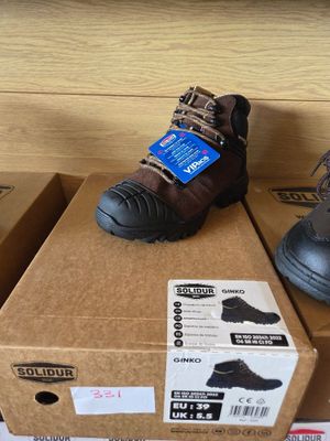 two pairs of shoes that are on top of a box