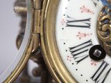 a close up of a clock with roman numerals on it