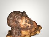 statue of a sleeping lion on a gold plate