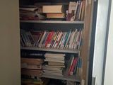 a book shelf full of books in the corner of a room