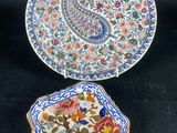 two plates and a small plate with a paisley design on them