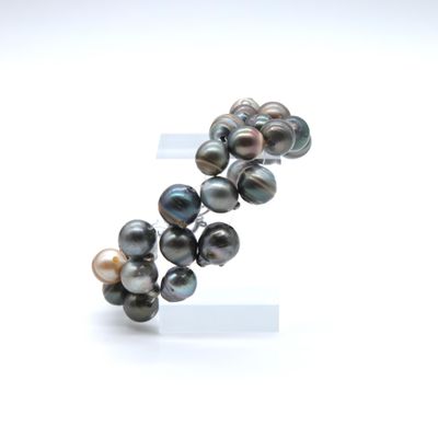 an image of a close up of a bracelet with pearls on it