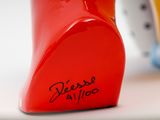 a close up of a red vase with writing on it