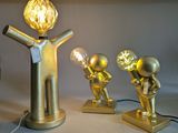 three gold figurines that are on a table