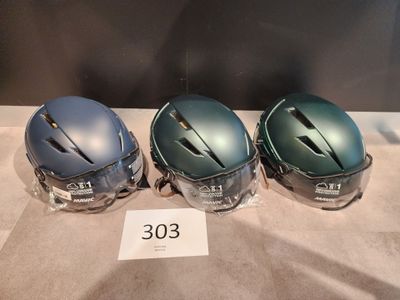three helmets are lined up on a table with a price tag