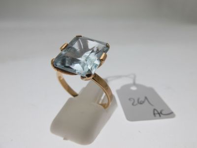 an image of a ring with a blue topazt stone on it