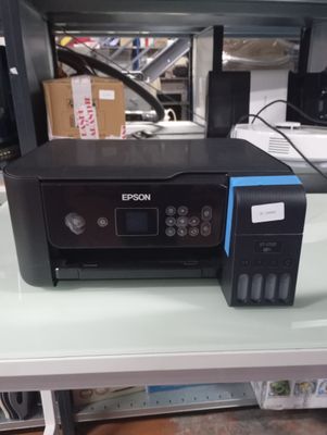a printer sitting on top of a desk next to a printer