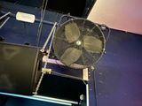 a fan that is hanging from the ceiling in a room