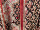 a close up of a black and red paisley print jacket
