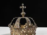 an image of a gold crown sitting on top of a white table