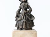 statue of a woman with a basket of flowers on a marble base