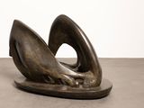 bronze sculpture of a bird on a plate with a white background