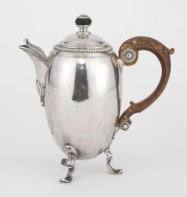 a silver teapot with a wooden handle and a handle