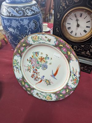 a plate that is sitting on a table with a clock in the background