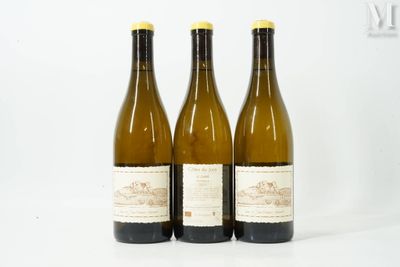 three bottles of wine sitting next to each other on a white surface