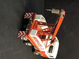 a toy truck with a crane attached to it ' s back