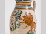 a large vase with a lion on it on a white surface