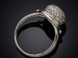 a close up of a diamond ring on a black surface
