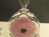 a glass vase with a pink flower inside of it