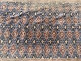 a close up of a blue rug with a diamond pattern on it