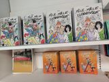 many books on a shelf in a book store