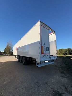 the trailer is parked on the side of the road in the parking lot