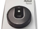 an image of a box with a robotic vacuum on top of it