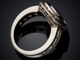 a close up of a diamond ring on a black surface